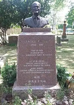 Bronze bust of Layton atop of a red granite pillar