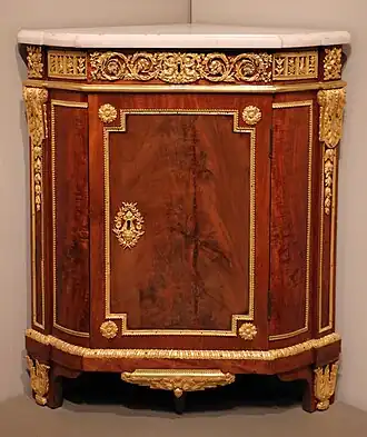 Louis XVI corner cabinet; by Jean Henri Riesener; 1780–1790; oak, mahogany, marble, and gilt-bronze mounts; 94.3 × 81.3 × 55.9 cm; Art Institute of Chicago (US)[5]