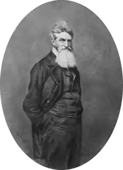Photograph of John Brown, wearing a suit and a large bushy beard