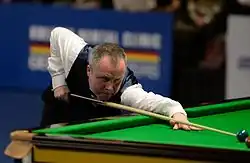 John Higgins playing a shot