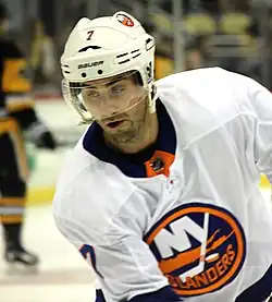 Ice hockey player in a white New York Islanders jersey