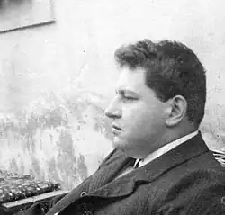 Black and white photo of a middle-aged white man with dark, short hair.