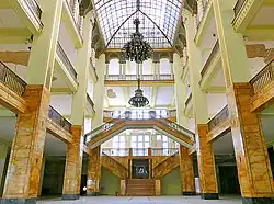Atrium of a large, multilevel building of a defunct department store flagship. Note the damaged ceiling in the background