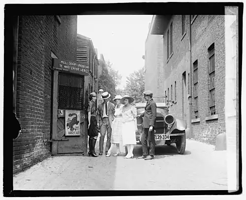 A flapper and patrons in front of The Krazy Kat, a Jazz Age speakeasy, in 1921. Critics touted Fitzgerald's This Side of Paradise as turning the national spotlight on the Jazz Age generation—those Americans younger than Fitzgerald who had been adolescents during World War I and whom Fitzgerald regarded as the true "lost" generation.