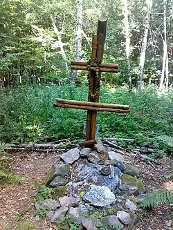 A cross and mound marking the site of the crash