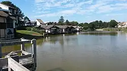 A lake with modern detached houses nearby