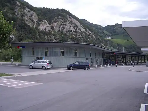 Two-story building with flat roof and rounded wall