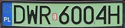 A rectangular plate with green background reading DWR6004H