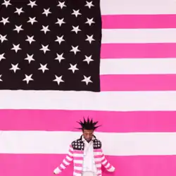 Uzi standing in front of a pink Amercian flag