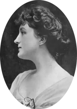 head and shoulders shot of young white woman with dark hair, seen in left profile