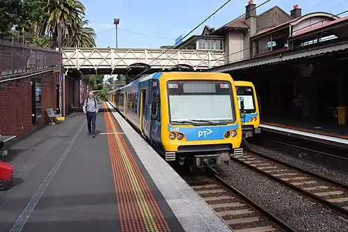 Two X'Trapolis trains pass by at Camberwell station