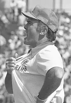 Black and white photo of a man in a shirt that says "Rams" and he is pulling on it and yelling.