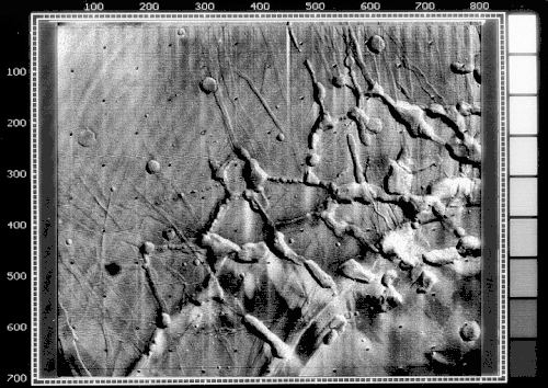 Mariner 9 view of the Noctis Labyrinthus "labyrinth" at the western end of Valles Marineris on Mars. Linear graben, grooves, and crater chains dominate this region, along with a number of flat-topped mesas. The image is roughly 400 km across, centered at 6 S, 105 W, at the edge of the Tharsis bulge. North is