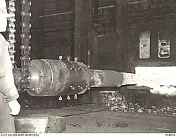 The barrel of a 3.7 inch anti-aircraft gun being drawn from the furnace