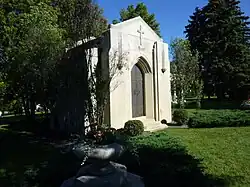 White stone mausoleum with iron doors and "Mars" engraved near the top