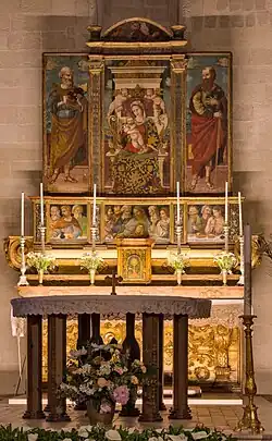 Main altar with the polyptych Madonna and Child with saints Peter and Paul (1540)