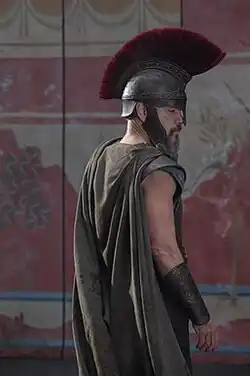 Picture of actor Matt Damon wearing a helmet and armor as Odysseus