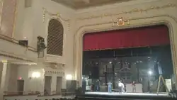 Stage right of the proscenium from center house.