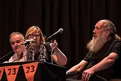Michelle Olley, center, hosting talk with Adam Curtis and Alan Moore, at Cosmic Trigger play event, London 2017 (photo: Beccy Strong)