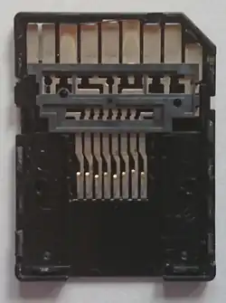 Dismantled microSD to SD adapter showing the passive connection from the microSD card slot on the bottom to the SD pins on the top.