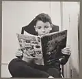 German refugee child, a devotee of Superman reading a Superman comic book, October 1942