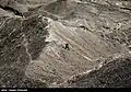 A NAJA border guard ranger on the Iran-Pakistan border climbing a mountain