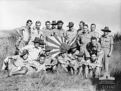 Image 72New Guinea Volunteer Rifles with captured Japanese flag, 1942 (from History of Papua New Guinea)