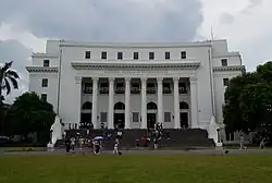 Neoclassical building facade with 6 fluted Corinthian columns. "NATIONAL MUSEUM OF ANTHROPOLOGY" is carved into the entablature.