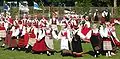 Women in traditional Saaremaa dress performing a folk dance