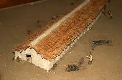 Photo of a model reconstructing a Neolithic farm with thatched roofs