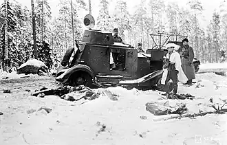 Destroyed Soviet armoured car is inspected by Finnish officers.
