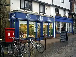 New Age store along stone street with bicycles parked out front and large crystals behind display windows