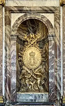 Baroque sculpture of cherubs holding a medallion with Louis XIV's monogram, unknown sculptor, late 17th-very early 18th century, Palace of Versailles, Versailles, France