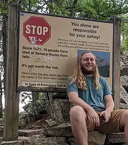A warning sign stating, "Since 1971, 15 people have died at Seneca Rocks from falls. It's not worth the risk."