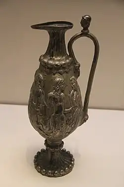 A ewer with Greco-Roman scenes from the tomb of Northern Zhou general Li Xian, 569 AD.[150][151] It was probably made in Bactria.[152]