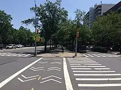 The western median as seen from Avenue C. There is a pedestrian and bicycle crossing across Avenue C in the foreground.