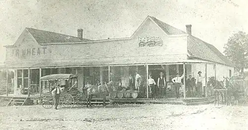 The original J.J. Putnam's general merchandise store, which later burned down and was replaced with a cement block building, which still stands on the southeast corner of Pickens Road and Curtis Avenue. This photo antedates 1914.