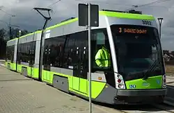 Green and grey three-section tram