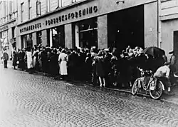 The German occupation saw a great rise in food shortages throughout Norway. Here people wait in line for food rations, Oslo, 1942.