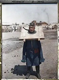 A convict (probably a soldier) serving the cangue in Ulan Baator, Mongolia, 1913. Photo by Stephane Passet for the Archives of the Planet.