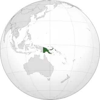 Papua New Guinea in green with Southeast Asia and other areas of Asia to its west and northwest, Australia to the south, and the large Pacific ocean to the east