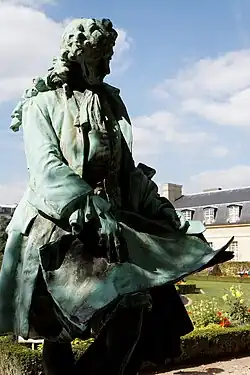 Statue of Jules Hardouin-Mansart. He studies an architectural drawing.