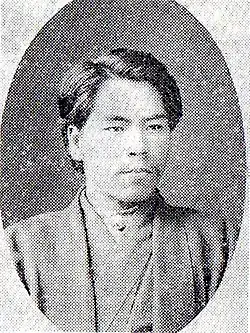 Black and white photograph of a man wearing a kimono