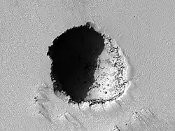 HiRISE image of a 180 m wide lava tube skylight on the volcano's southeast flank