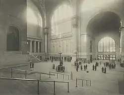 The main waiting room with stairs in the foreground, and a statue of PRR President Alexander Johnston Cassatt on the left.