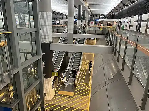 Large underground concourse with escalators and lifts down to platform level and up to ground level