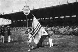 An athlete holding the flags of the United States and the Philippines