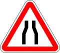 Road narrows on both side