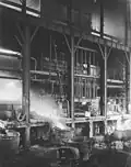 Great Cobar mine - Pouring molten copper matte from a water jacket furnace, viewed from inside the smelter building (June 1912)
