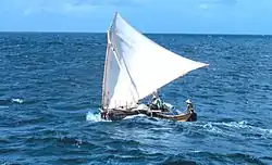 Carolinian single-outrigger shunting wa with a "crane sprit" crab claw sail on a canted mast